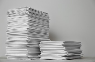 Photo of Stacks of paper sheets on wooden table