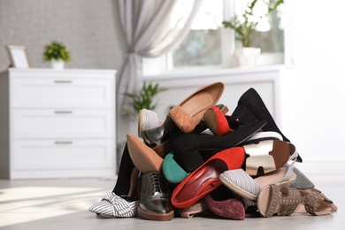 Photo of Pile of female shoes on floor indoors