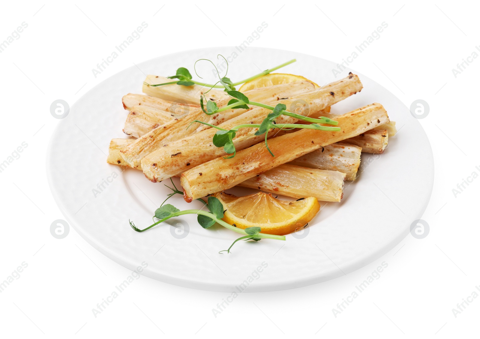 Photo of Plate with baked salsify roots and lemon isolated on white