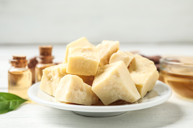 Organic cocoa butter on wooden table, closeup