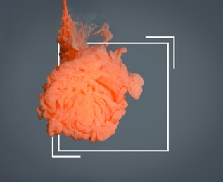 Image of Splash of orange ink and frame on grey background