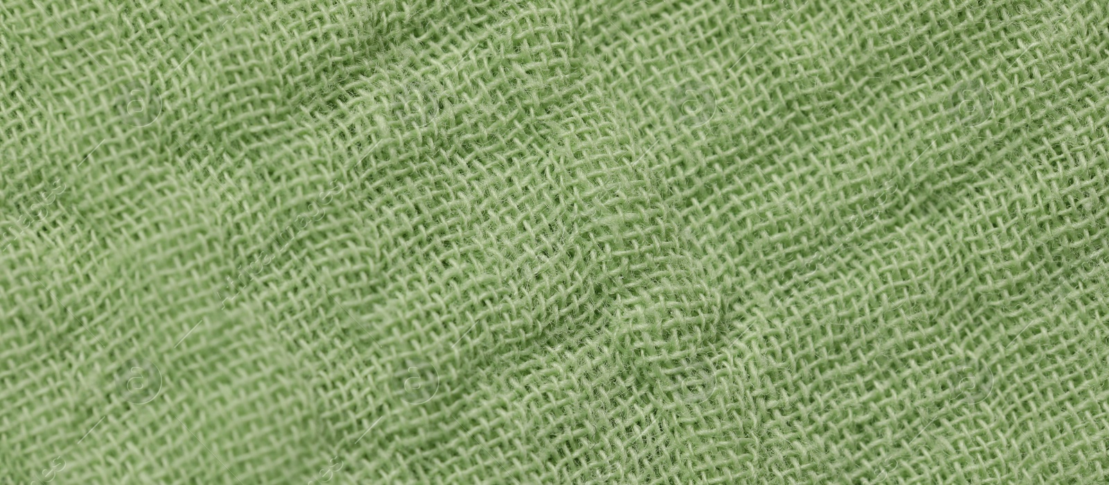 Photo of Texture of soft green fabric as background, top view