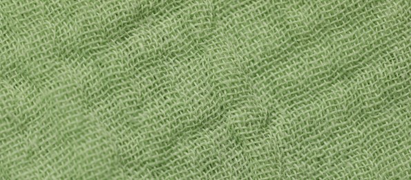 Texture of soft green fabric as background, top view