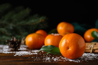 Photo of Tasty fresh tangerines on wooden table. Christmas celebration