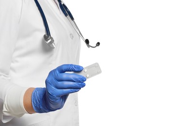 Doctor holding blister of emergency contraception pills on white background, closeup