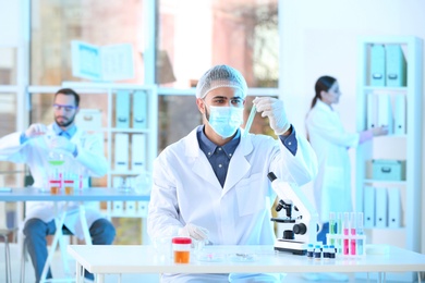 Photo of Young scientist working in laboratory. Chemical analysis