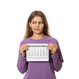 Emotional young woman holding calendar with marked menstrual cycle days on white background