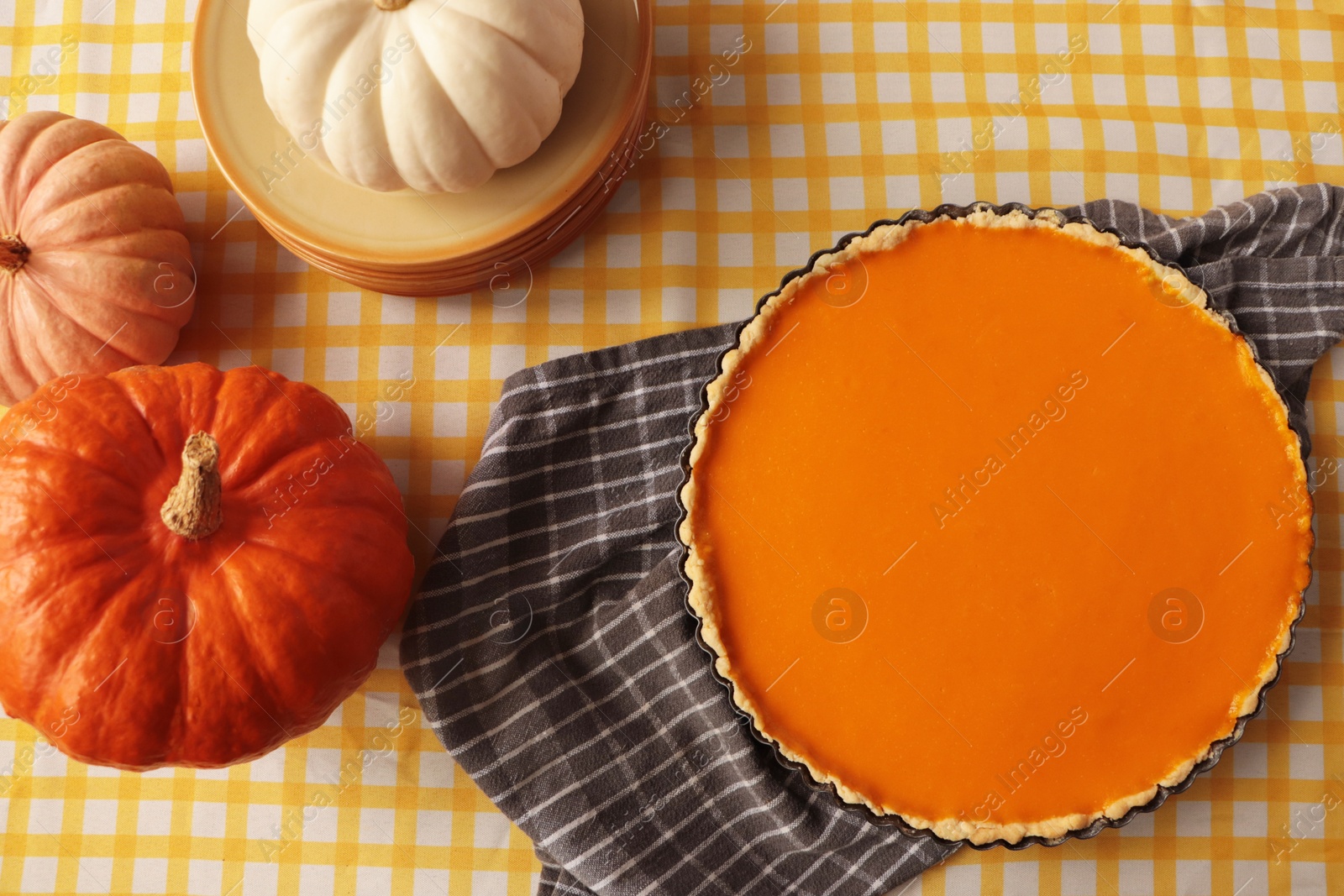 Photo of Delicious homemade pie and pumpkins on table, flat lay