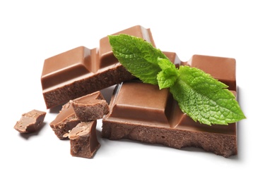 Photo of Pieces of milk chocolate with mint on white background