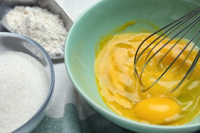 Whisking eggs in bowl on table, closeup