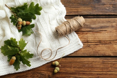 Flat lay composition with acorns on wooden table