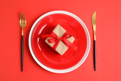 Photo of Elegant table setting for romantic dinner on red background, flat lay. Valentine's day celebration