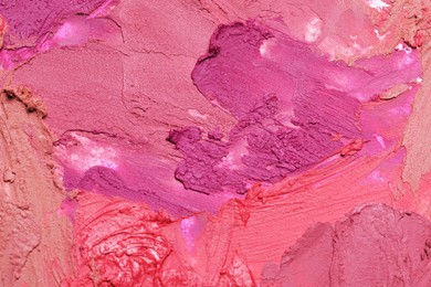 Photo of Texture of beautiful lipsticks as background, closeup