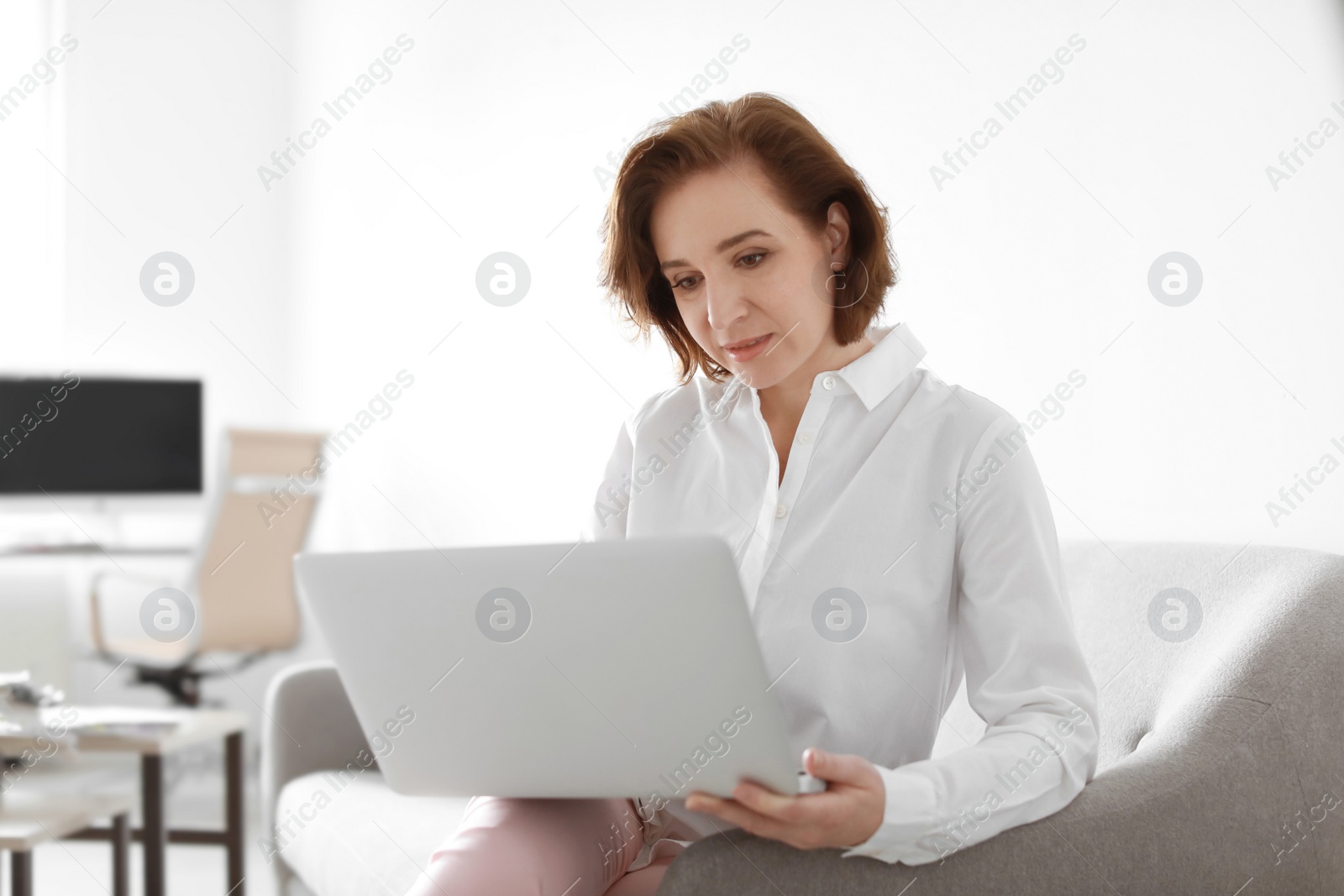 Photo of Female lawyer working with laptop in office