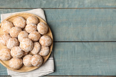 Plate with tasty homemade gingerbread cookies on blue wooden table, top view. Space for text