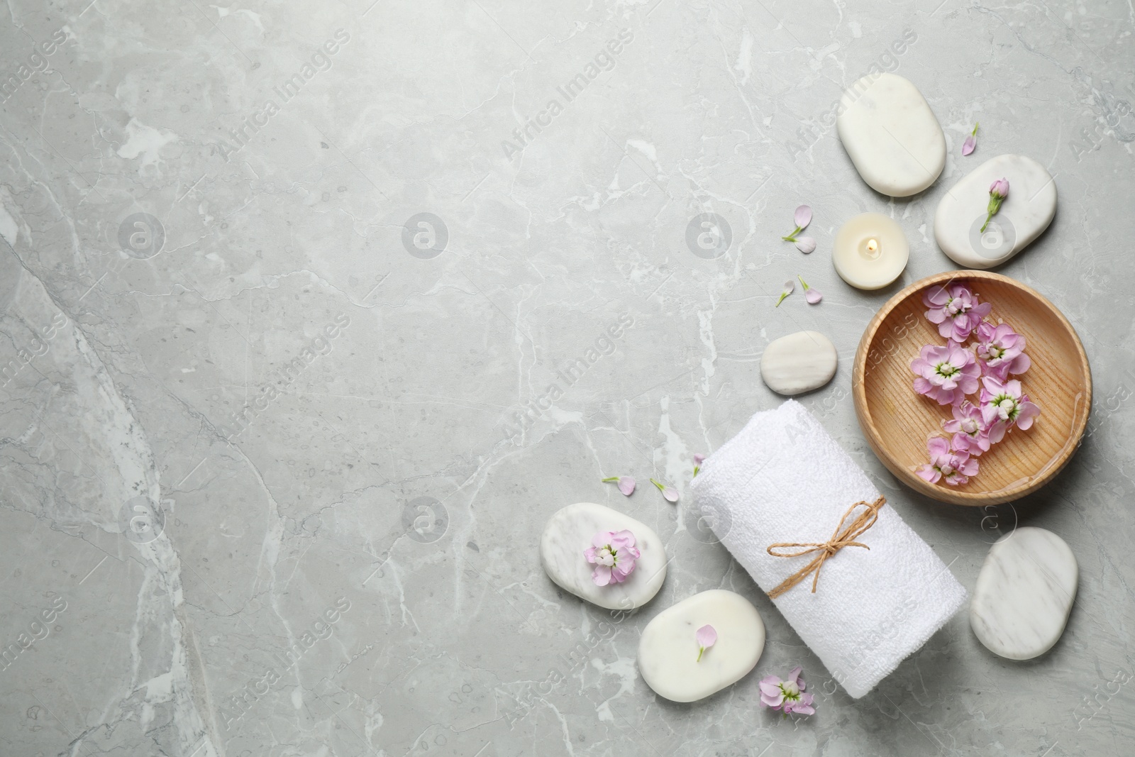 Photo of Flat lay composition with spa stones on light grey marble table, space for text