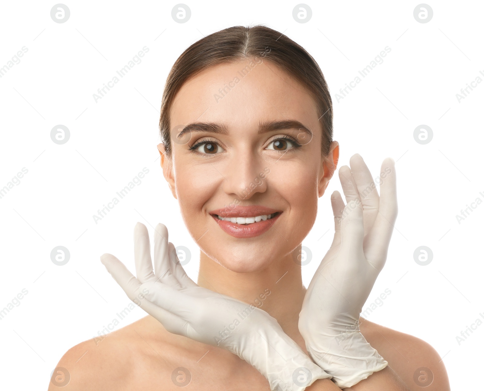 Photo of Doctor examining woman's face before plastic surgery on white background