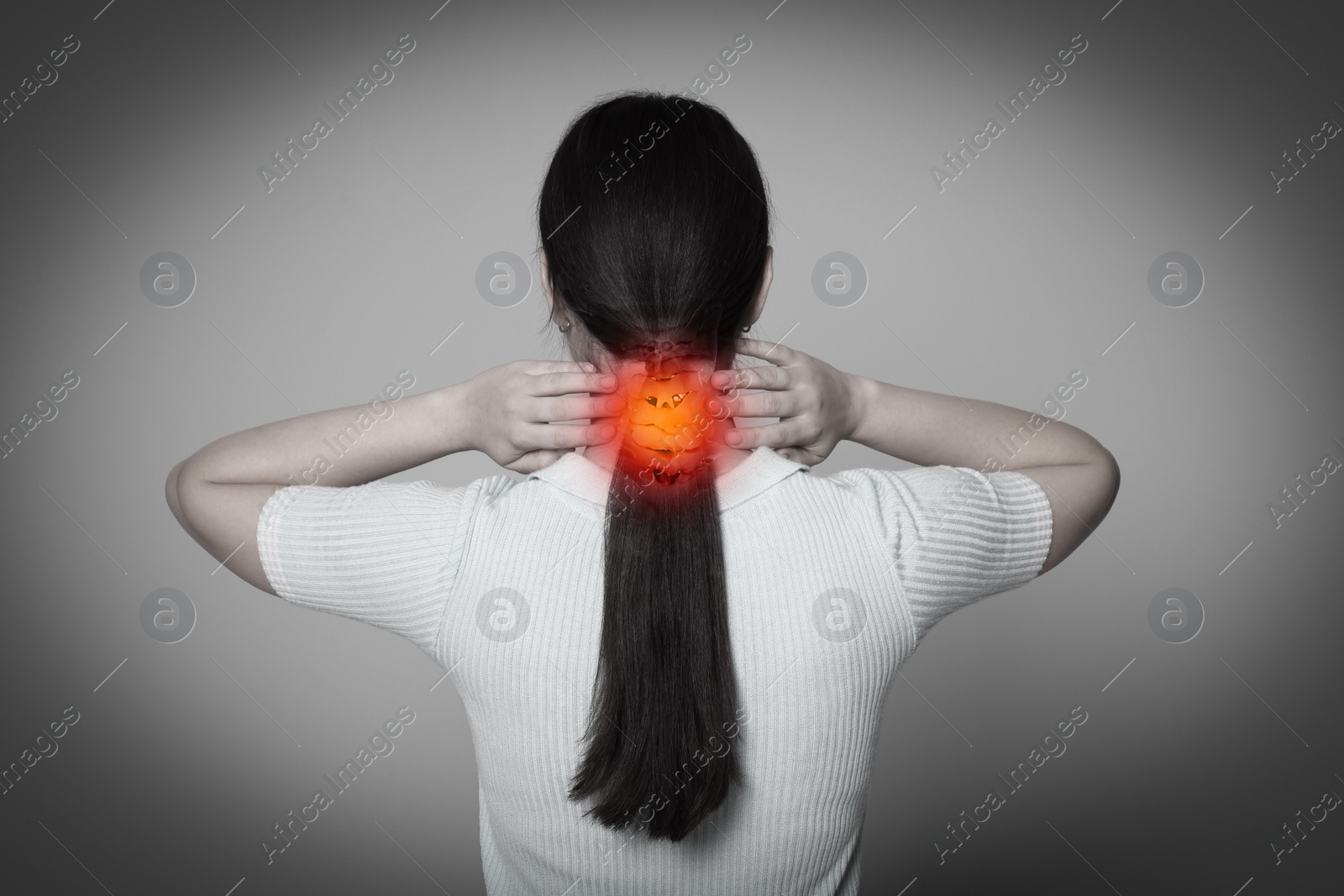 Image of Arthritis symptoms. Young woman suffering from pain in neck on light grey background, back view