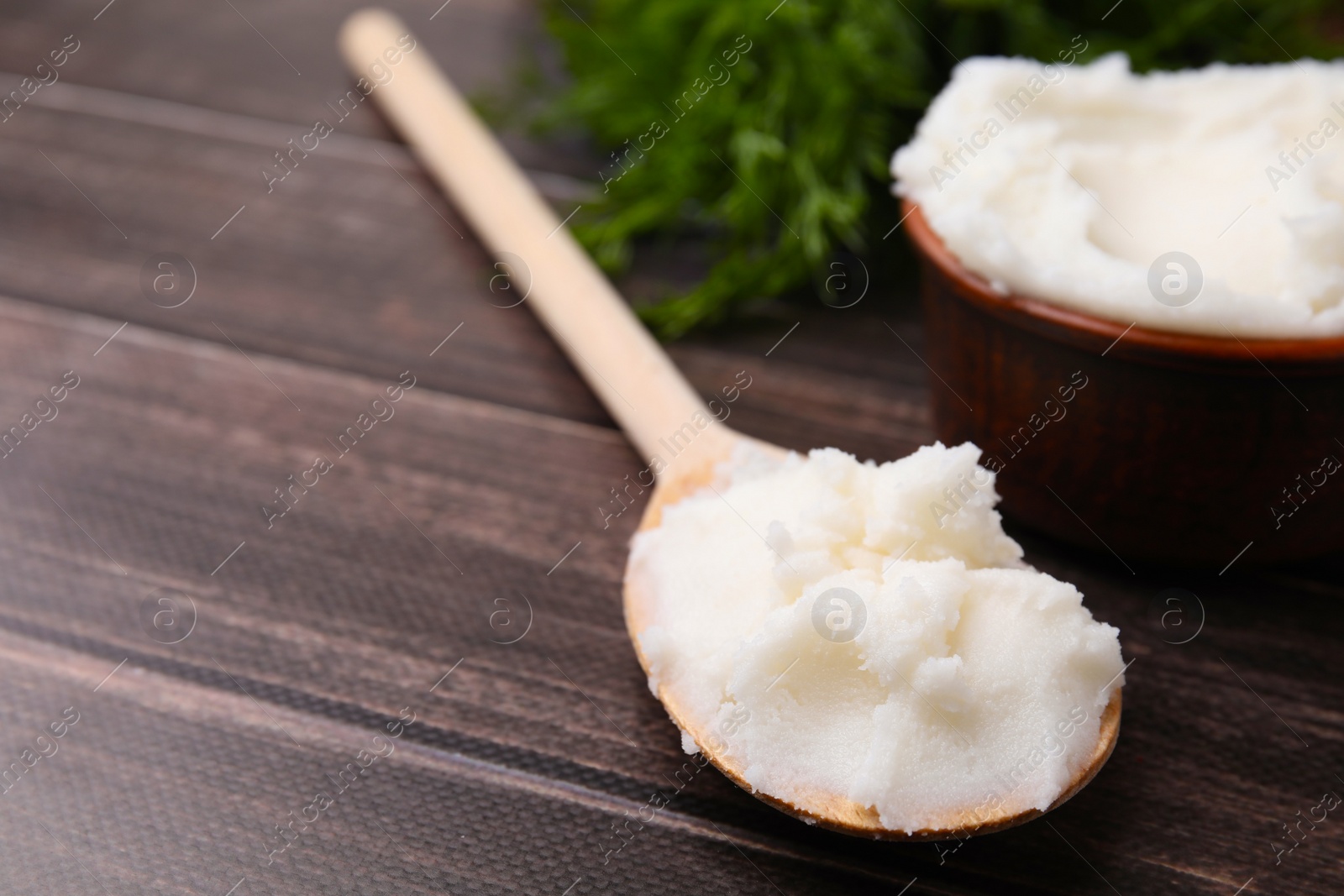 Photo of Spoon with delicious pork lard on wooden table, closeup. Space for text