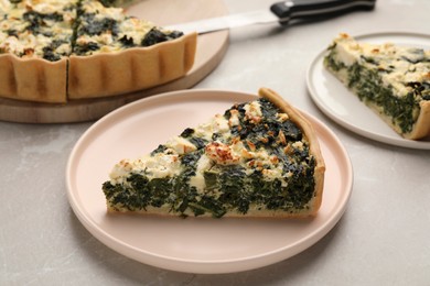 Pieces of delicious homemade spinach quiche on light table