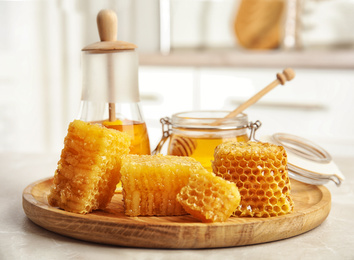 Photo of Fresh delicious honeycombs on light marble table