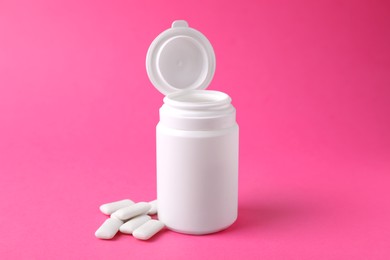 Photo of Jar with chewing gums on pink background