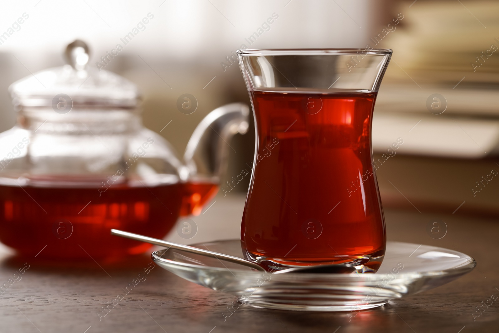 Photo of Glass of traditional Turkish tea on wooden table, closeup. Space for text