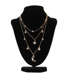 Photo of Stylish golden necklace on jewelry bust against white background