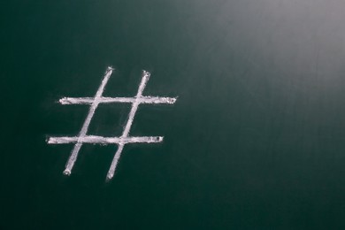 Photo of Hashtag symbol drawn with chalk on blackboard. Space for text