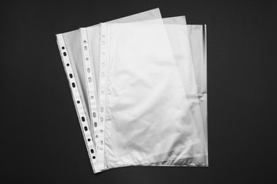 Photo of Punched pockets on black background, flat lay