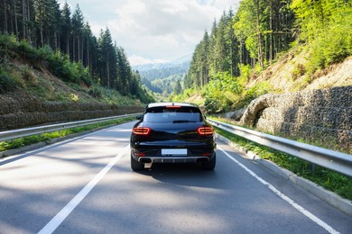 Photo of Picturesque view of asphalt road with modern car