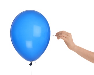Photo of Woman piercing blue balloon on white background