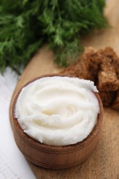 Photo of Delicious pork lard in bowl on wooden table, closeup