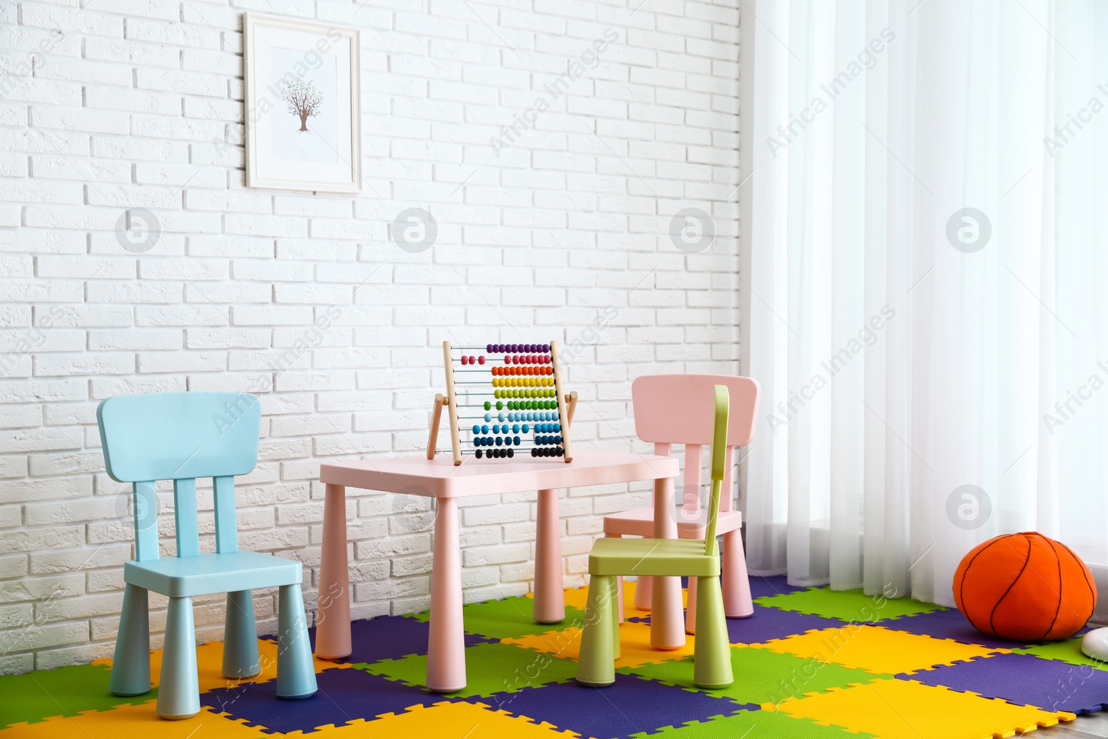 Photo of Stylish playroom interior with toys and modern furniture. Space for design