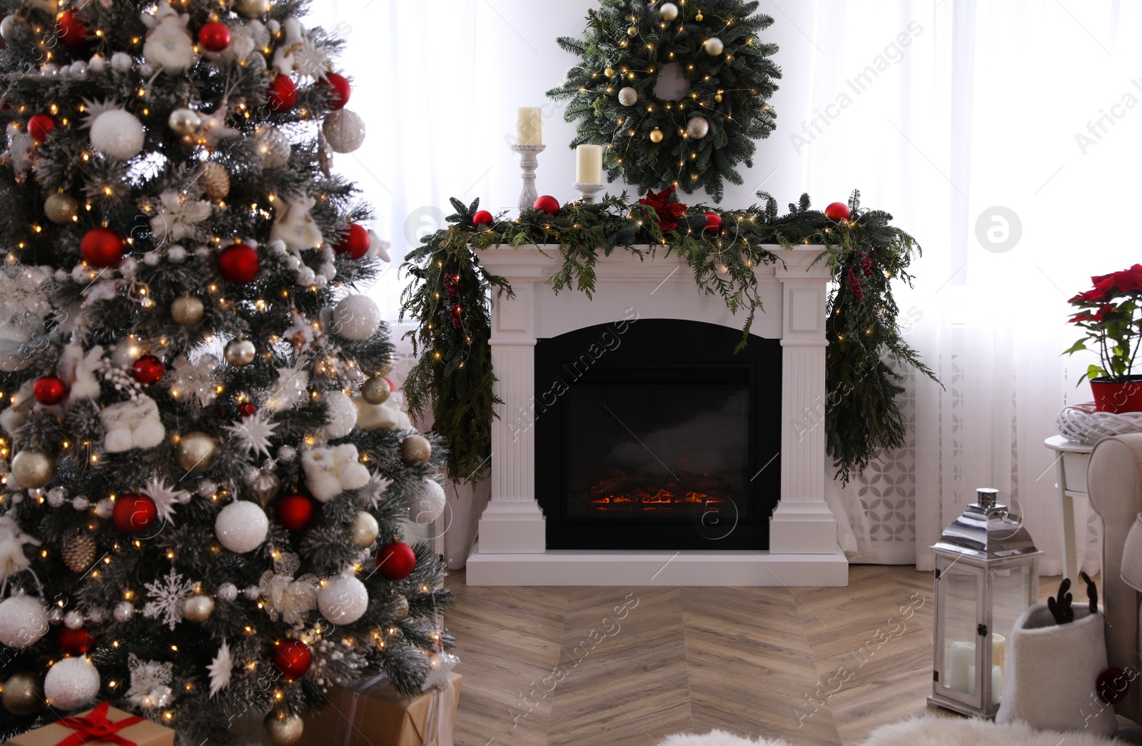 Photo of Festive room interior with Christmas tree and fireplace