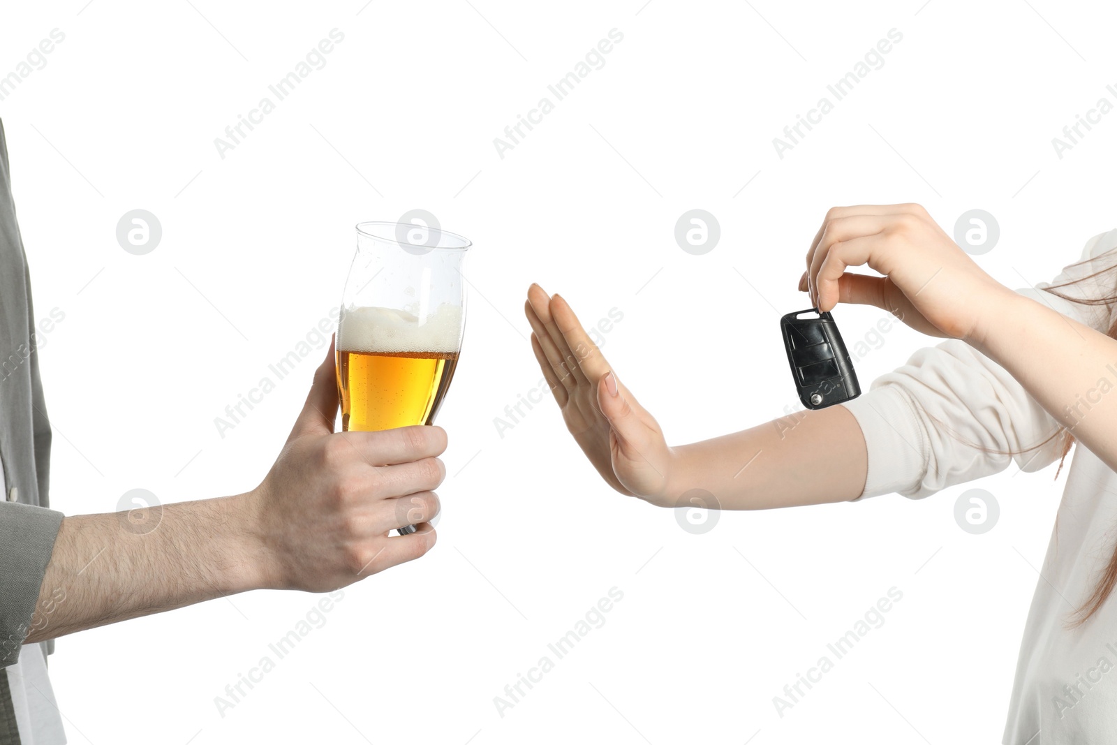 Photo of Woman with car keys refusing alcohol while man suggesting her beer on white background, closeup. Don't drink and drive concept