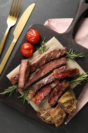 Photo of Delicious grilled beef with vegetables and rosemary served on table, flat lay