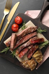 Delicious grilled beef with vegetables and rosemary served on table, flat lay