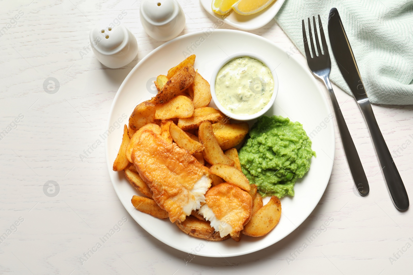 Photo of British Traditional Fish and potato chips on wooden background, flat lay