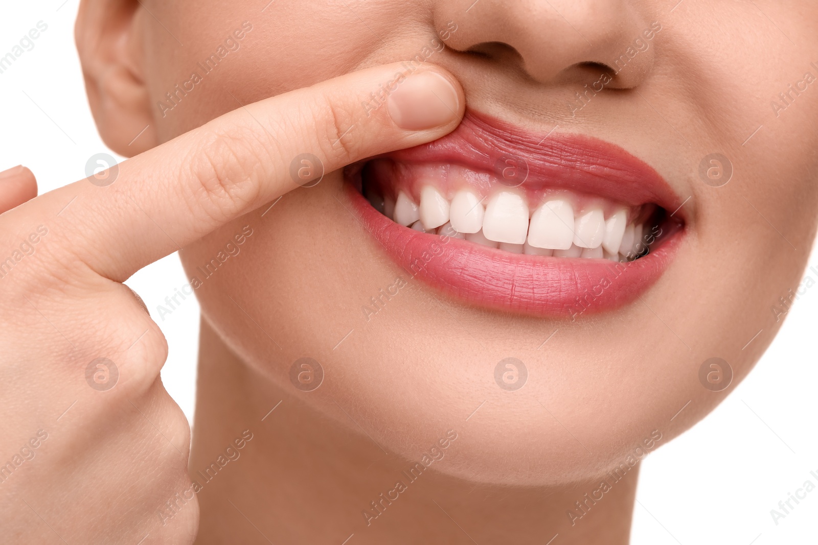 Photo of Woman showing her clean teeth on white background, closeup