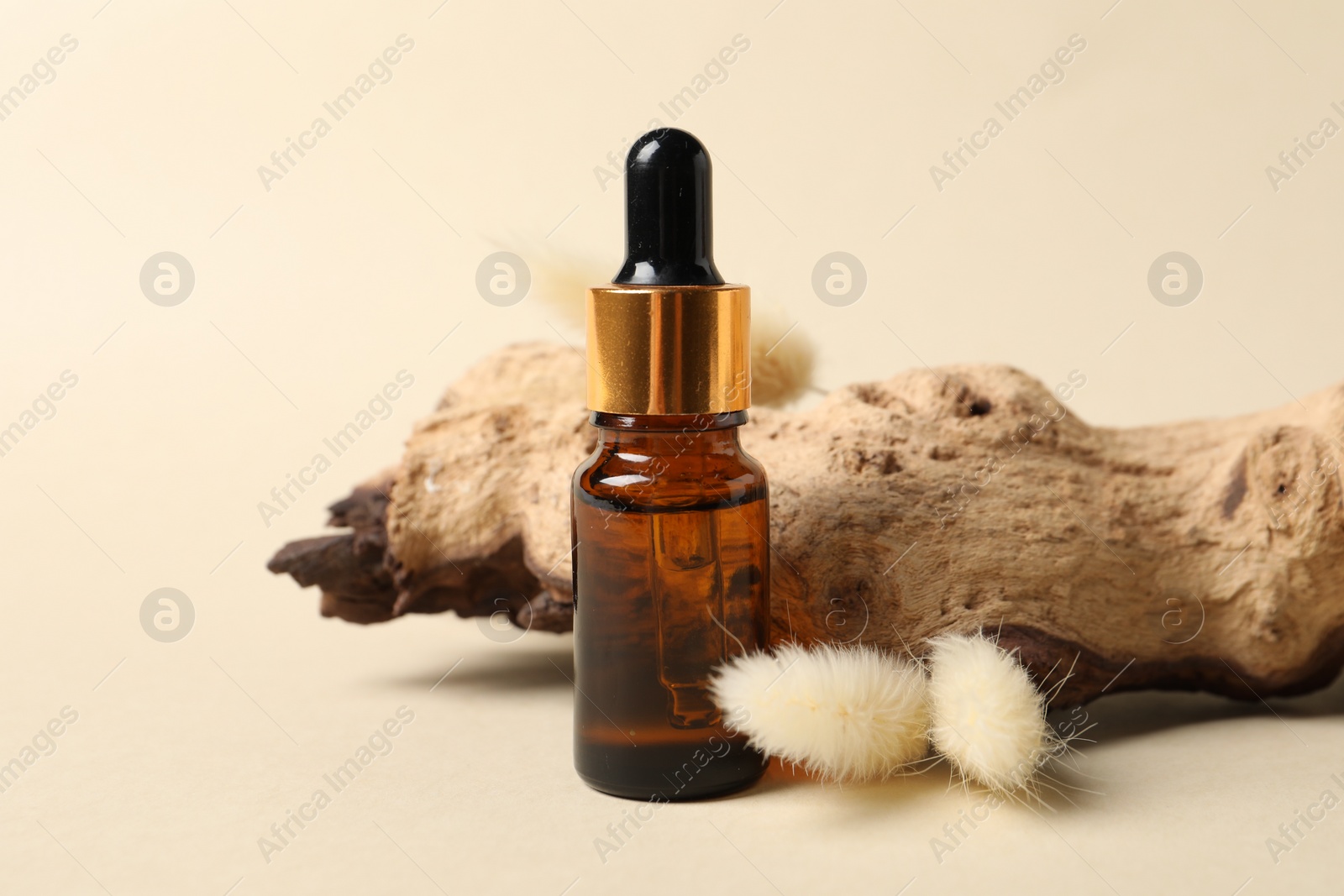 Photo of Composition with bottle of cosmetic serum on beige background