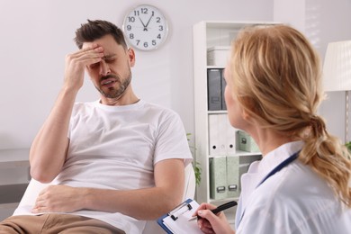 Doctor listening to patient's complaints during consultation in clinic