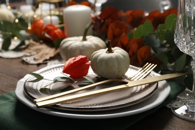 Photo of Beautiful autumn table setting. Plates, cutlery and floral decor, closeup