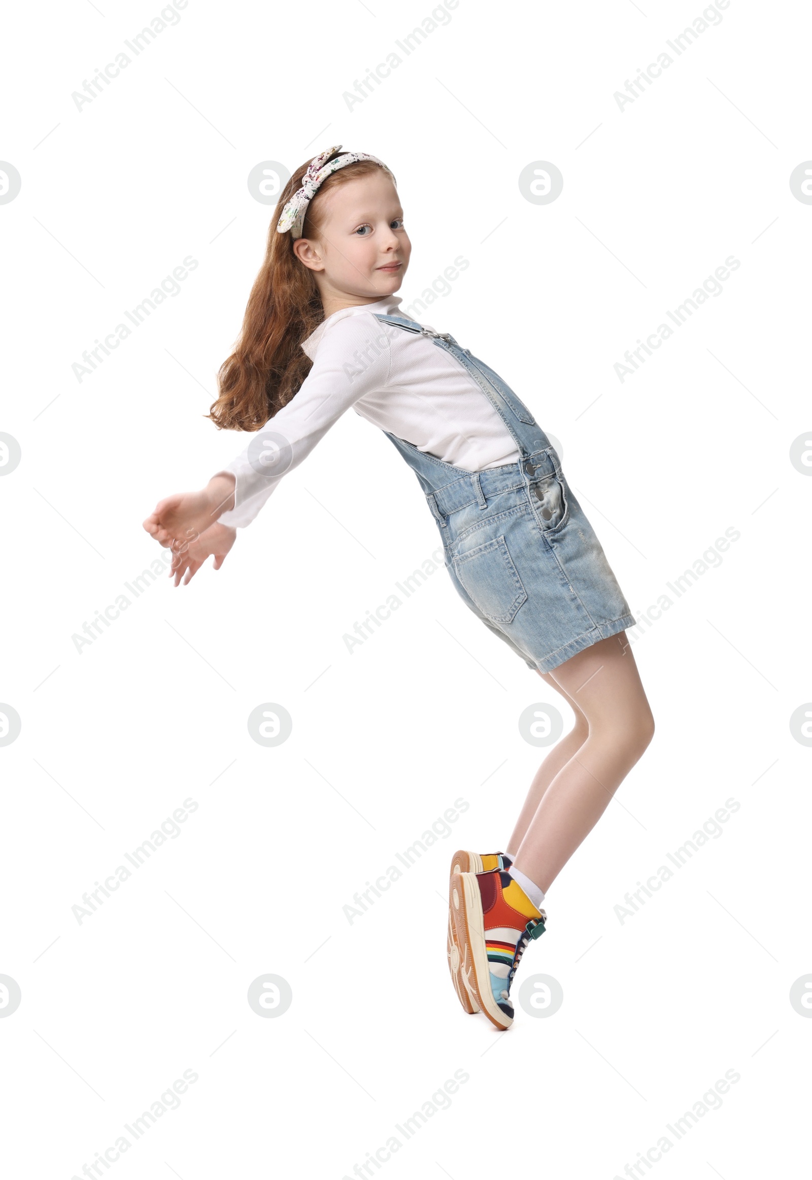 Photo of Cute little girl dancing on white background