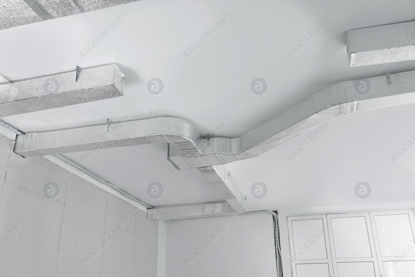 Photo of Ceiling with ventilation system indoors, low angle view