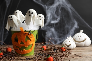 Photo of Ghost shaped cake pops on wooden table, space for text. Halloween treat
