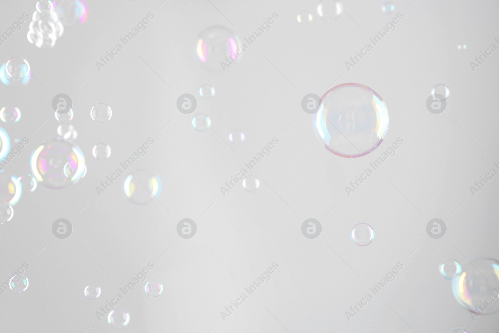 Photo of Beautiful transparent soap bubbles on grey background