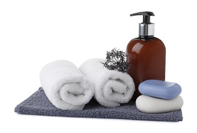 Photo of Soap bars, liquid dispenser and terry towels on white background
