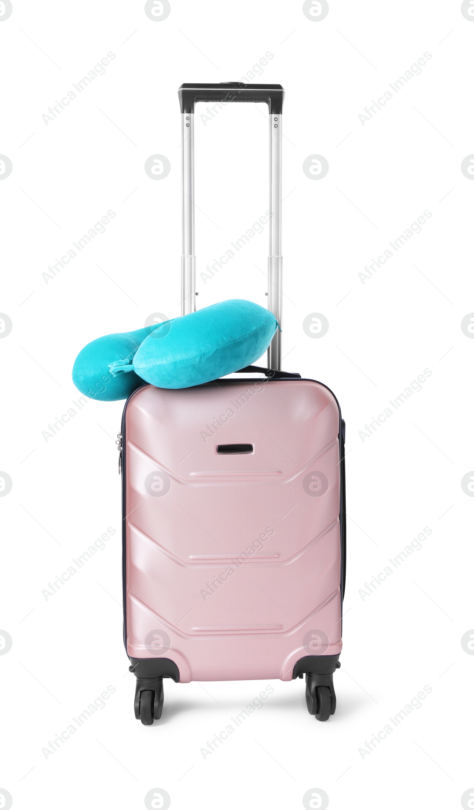 Photo of Light blue travel pillow on suitcase against white background