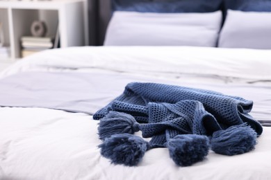 Photo of Soft blue plaid on bed in room, closeup